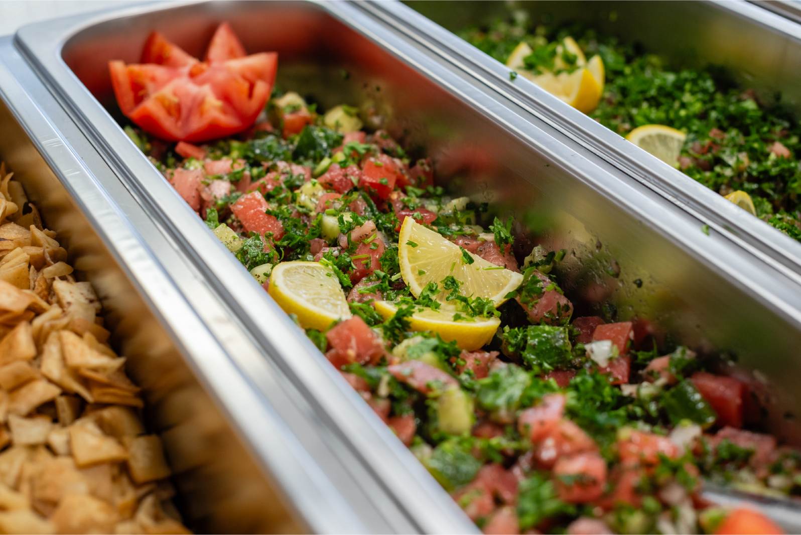 A tray of food with tomatoes and other vegetables.